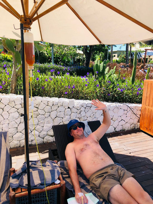 Two guests receiving IV drip therapy together at a Bali villa pool - Ever Well Health immune boost IV drip